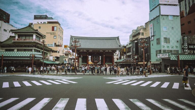 View of Senso-ji Temple and busy Asakusa district in Tokyo, Japan, bustling with visitors.
